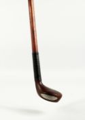 A SMALL WALKING STICK, the handle as a golf club. 32ins long.