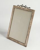 A GOOD GOLDSMITH AND SILVERSMITH CO. SILVER PHOTOGRAPH FRAME with ribbon motif. London 1910