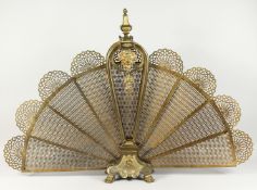 A VERY GOOD FRENCH ORMOLU PIERCED FAN SHAPED FIREGUARD, with masks on claw feet. 2ft 7ins high