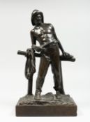 P. KOMDLEZEUSKI A BRONZE OF A FISHERMAN standing in front of a fence, signed, 12ins high, on a