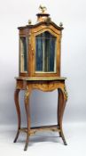 A GOOD LOUIS XVI STYLE SERPENTINE FRONTED STANDING DISPLAY CABINET, with rich ormolu mounts, the