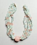 A FOUR ROW QUARTZ AND AQUAMARINE NECKLACE with gold clasp