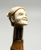 A CHINESE BAMBOO STICK WITH CHINESE MAN HANDLE and silver band