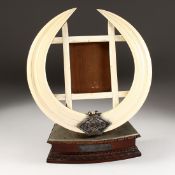 A LARGE BOARS TUSK PHOTOGRAPH FRAME, presented and made by BHOVAN BOGHA MISTRI, JETHHA MISTRI,