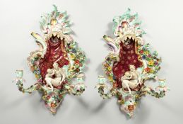 A GOOD PAIR OF MEISSEN PORCELAIN TWO LIGHT WALL SCONCES encrusted with flowers and scrolls, filled