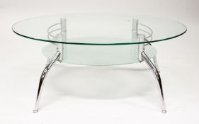 A MODERN GLASS AND CHROME TWO TIER OVAL COFFEE TABLE. 3ft 7ins long x 1ft 11.5ins wide x 1ft 5ins
