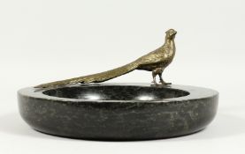 A LARGE MARBLE BOWL with a cast model of a long tailed pheasant. 12ins diameter.