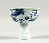 A CHINESE BLUE AND WHITE STEM CUP decorated with dragons 3.75ins diameter.