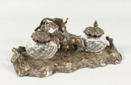A GOOD BRONZE INKWELL, girl with a horse in a rustic setting. 9ins long.
