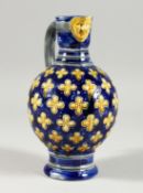 A MINTON MAJOLICA BLUE GROUND VASE with mask spout. 8ins high.