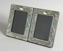 A PAIR OF ART NOUVEAU STYLE SILVER AND ENAMEL PHOTOGRAPH FRAMES 7.5ins x 5.5ins