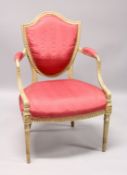 A GEORGE III SHIELD BACK ARM CHAIR with padded back arms and seat on turned fluted legs.