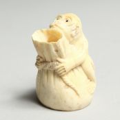 A CARVED BONE MONKEY VASE 2ins high