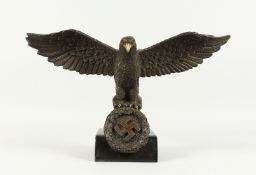 A BRONZE NATIVE EAGLE on a marble base. 17ins wide.