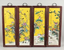 A SET OF FOUR CHINESE FRAMED PORCELAIN PLAQUES. 29ins long 8ins wide.