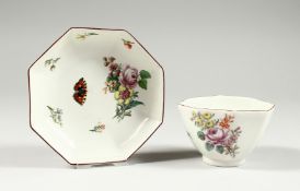 A CHELSEA OCTANGONAL TEABOWL AND SAUCER, painted with flowers and insects, red anchor mark.