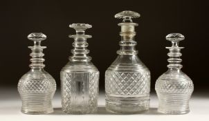 A PAIR OF CIRCULAR HOBNAIL CUT DECANTER AND STOPPERS. 7ins high, and two other DECANTERS (4).