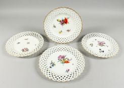 A SET OF FOUR MEISSEN WHITE GROUND PIERCED PLATES of raised lattice design and painted flowers.