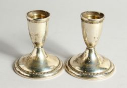 A PAIR OF EMPIRE STERLING SILVER CIRCULAR CANDLEST5ICKS 3.5ins high