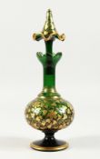 A BOHEMIAN GREEN AND GILT DECANTER AND STOPPER 10.5 ins high.