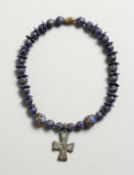 A ROMAN BEAD BRACELET with crucifix pendant.