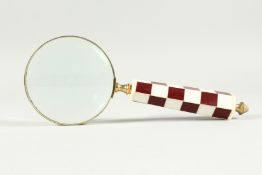 A MAGNIFYING GLASS WITH CHEQUERED HANDLE