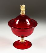 A SALVIATI RED JUG AND COVER with gilt seahorse handles 10ins high.