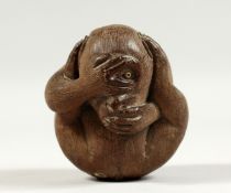 A JAPANESE CARVED WOOD MONKEY. Signed, 3ins high.