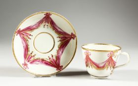 A WORCESTER RARE TEACUP AND SAUCER, the cup with entwined handle painted in the Sormont pattern.