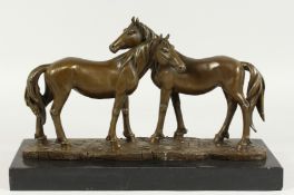MILO - A GOOD BRONZE OF TWO HORSES on a marble base. Signed, 15ins long.