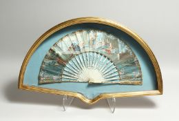 AN 18TH CENTURY FRENCH IVORY AND PAPER FAN, with classical figures in a palatial setting.
