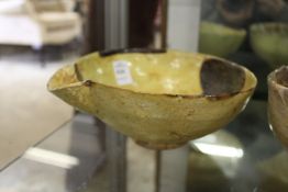 An Iran style pottery pouring bowl.