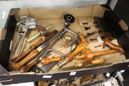 A good collection of early woodworking tools to include a brace and a collection of bits.