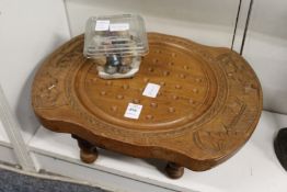 A Solitaire board and marbles.