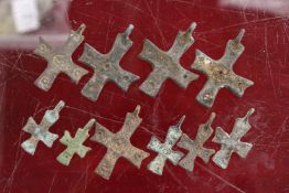 A group of small bronze crucifixes.