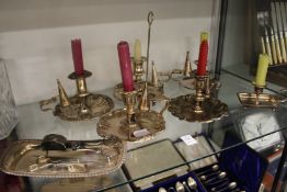 A collection of plated chamber sticks and snuffer tray and snuffers.