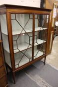 A mahogany standing two door display cabinet.
