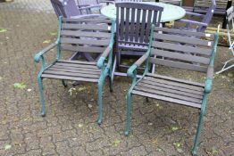 A pair of hardwood and metal garden armchairs.