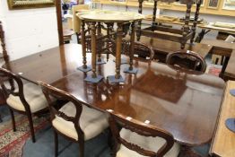 A good reproduction mahogany twin pillar extending table with one extra leaf.