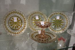 A set of four amber tinted cut glass dishes and a similar pedestal bowl.