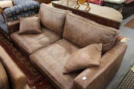 A modern large leather two seater settee.