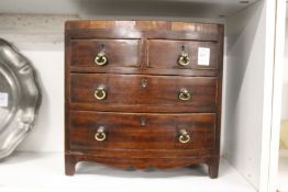 A good miniature George III mahogany bow fronted chest of drawers.