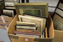A box of paintings and prints.
