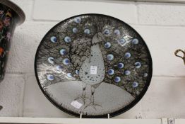 A good large Poole pottery charger painted with a peacock.