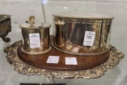 A plated box and cover, a drum mustard and a cheese board.