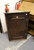 An oak hanging corner cupboard.