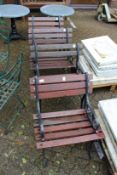 A set of four wooden and cast metal garden seats.