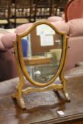 A small shield shaped dressing table mirror.