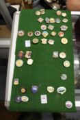 A collection of enamel badges.