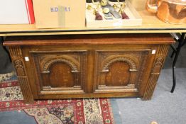 An oak coffer with carved panelled front.